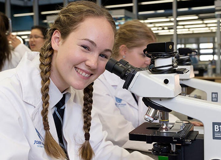 JMSS Student Smiling With Microscope