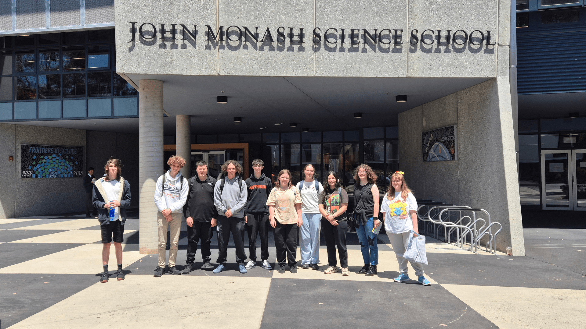 a group of male and female students standing in front of John Monash Science School