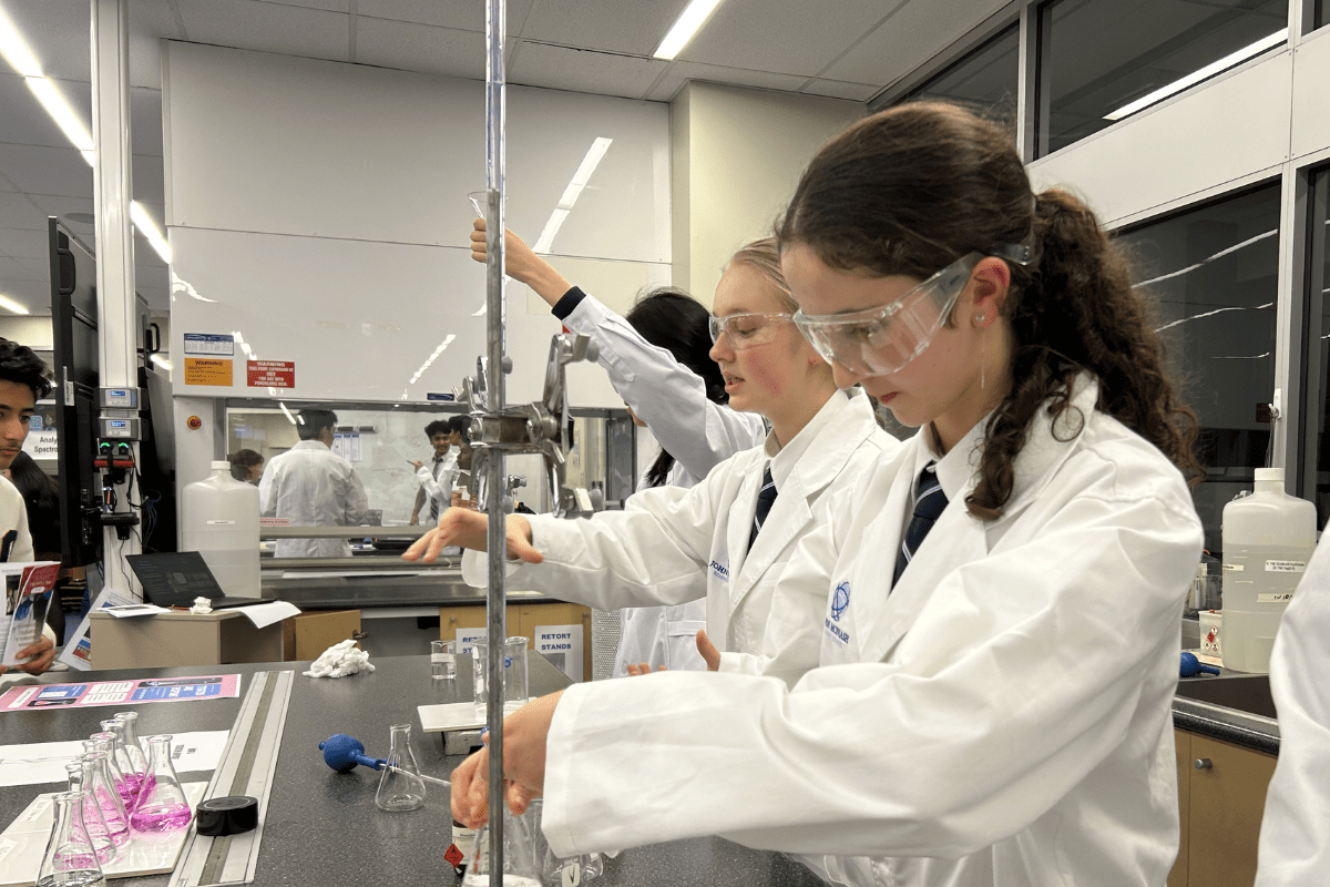 two girls demonstrating a science experiment