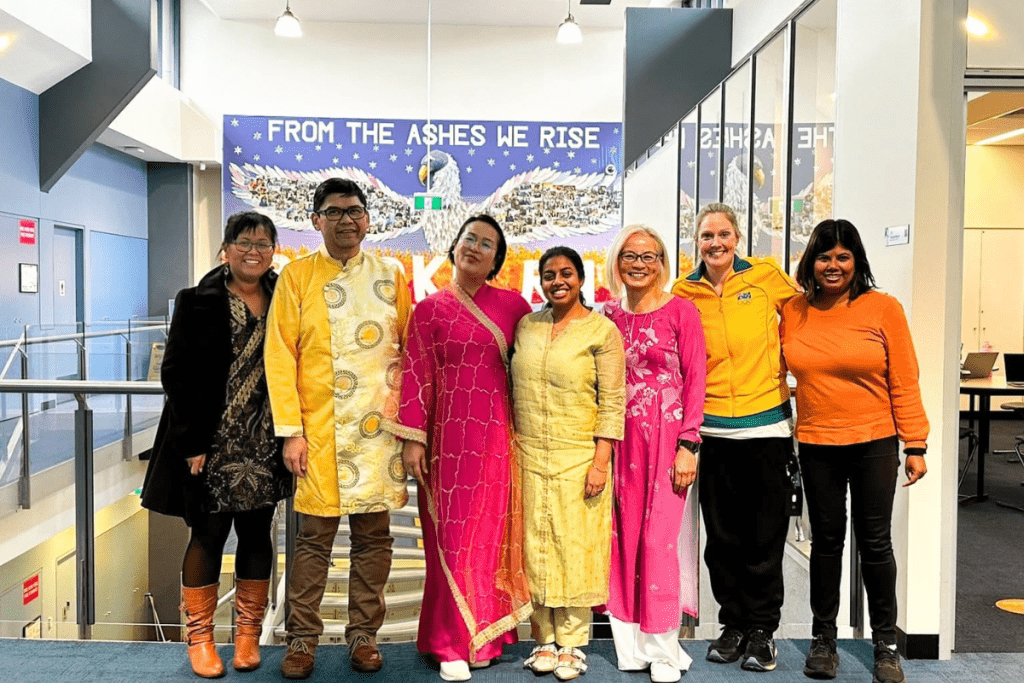 A group of people posing for a group photo, wearing traditional costume