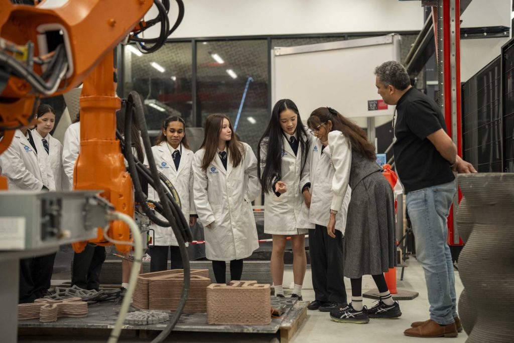 Students examine 3d printed products in a studio