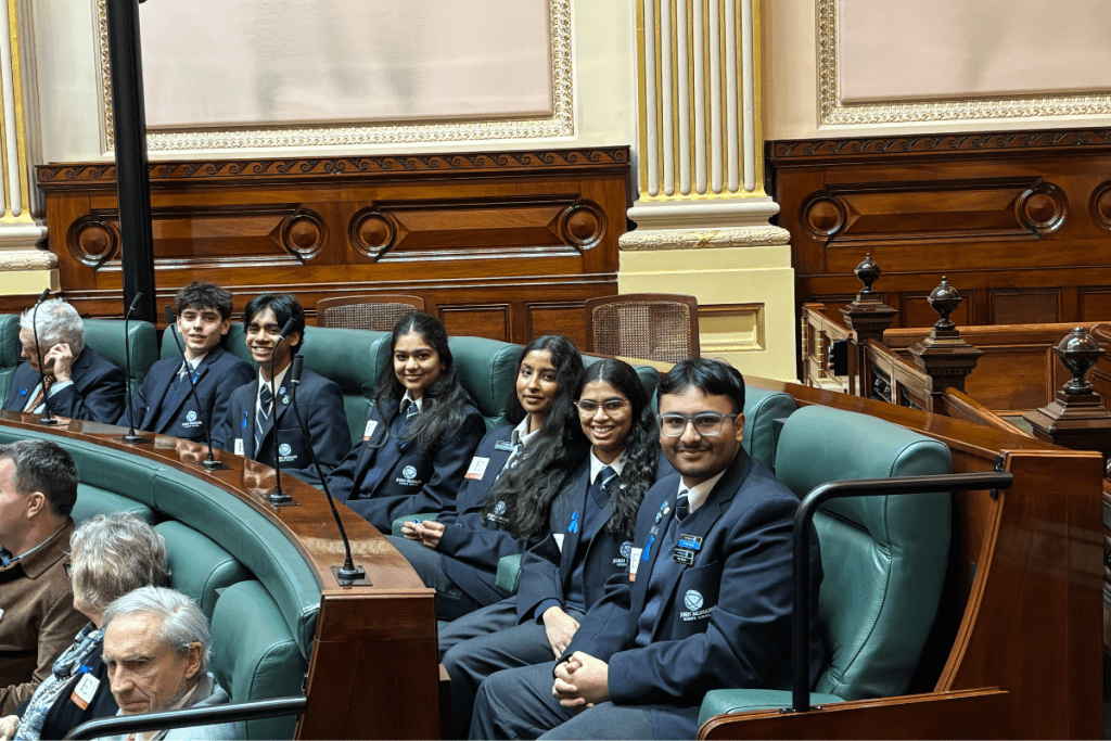 A group of students siting in the parliament 