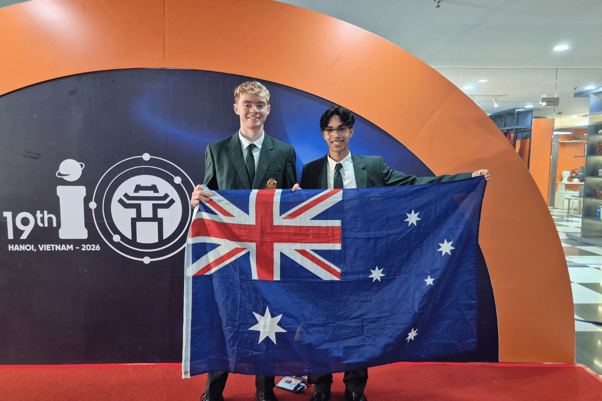 Two student holding an Australian flag