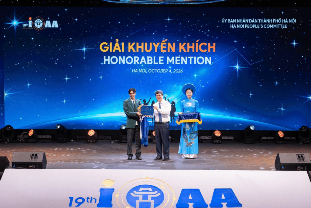 A student receiving a certificate on a stage, shaking hands with an official looking man